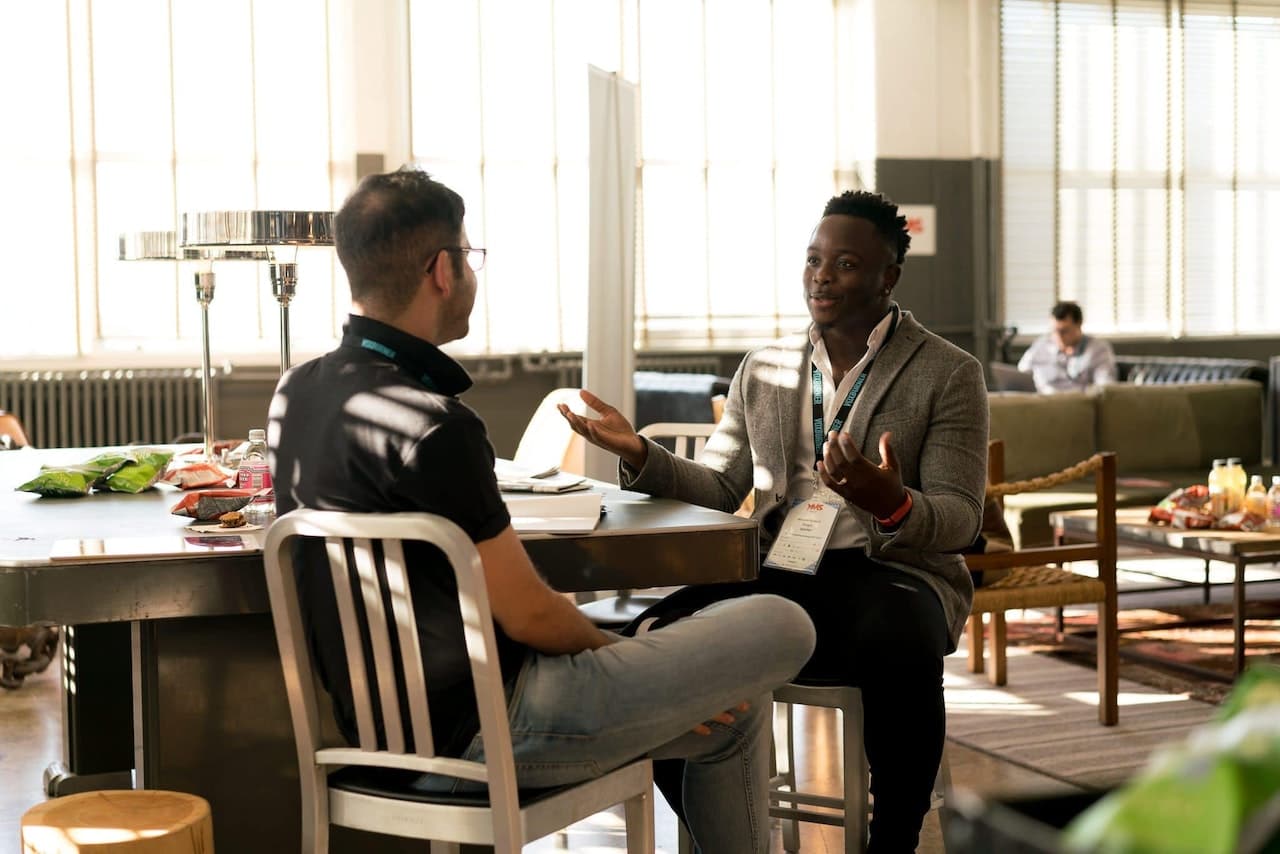 Two professionals in a focused advisory conversation