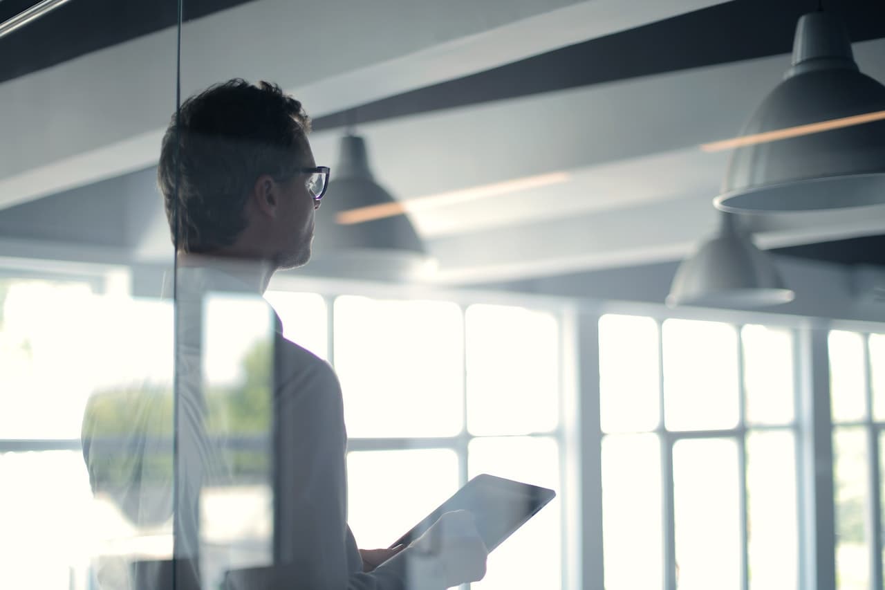 Consultant reviewing work on a tablet in a modern office
